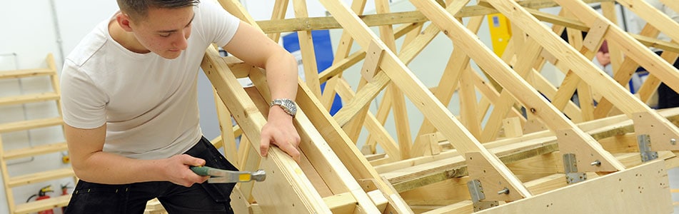 Student working on a roof